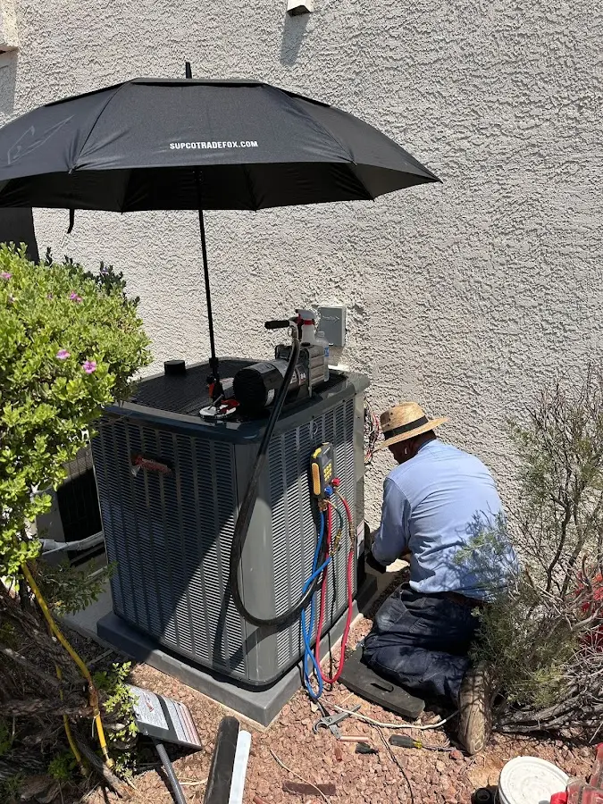 HVAC technician performing outdoor AC maintenance in Matthews